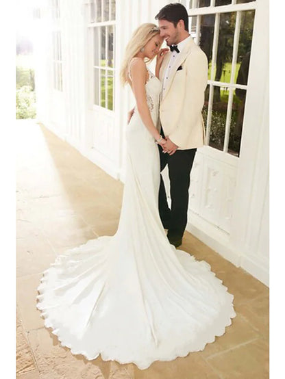 Side profile of a bride wearing a white mermaid trumpet wedding dress.