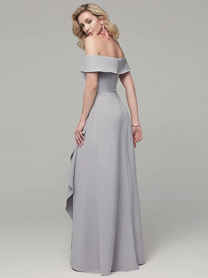 Model posing in the elegant off-shoulder gown, showcasing the back detail.