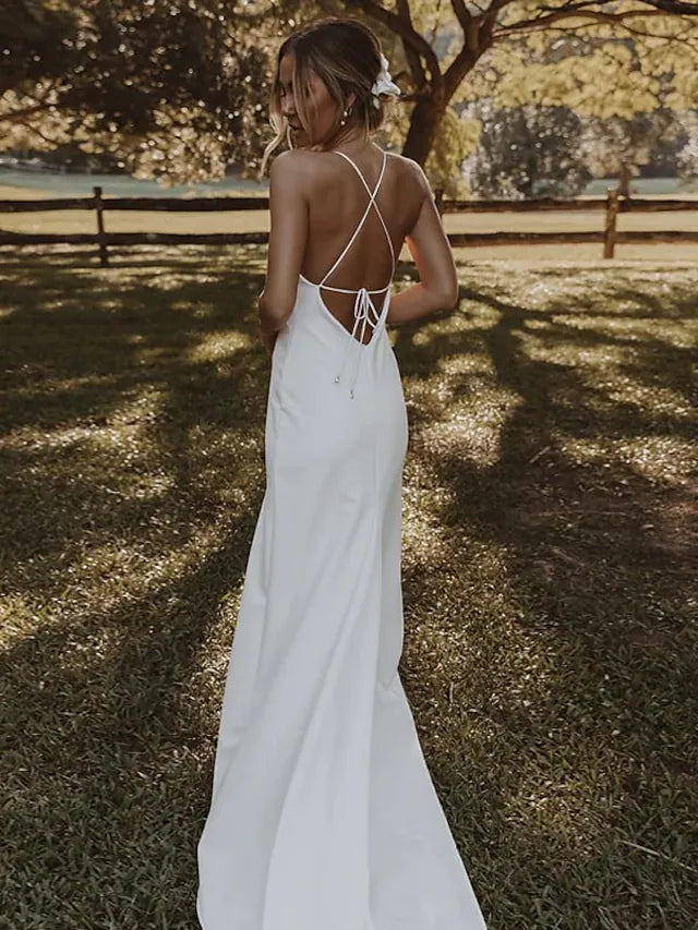 Back view of one-shoulder chiffon bridesmaid dress showing elegant draping and ruffles.