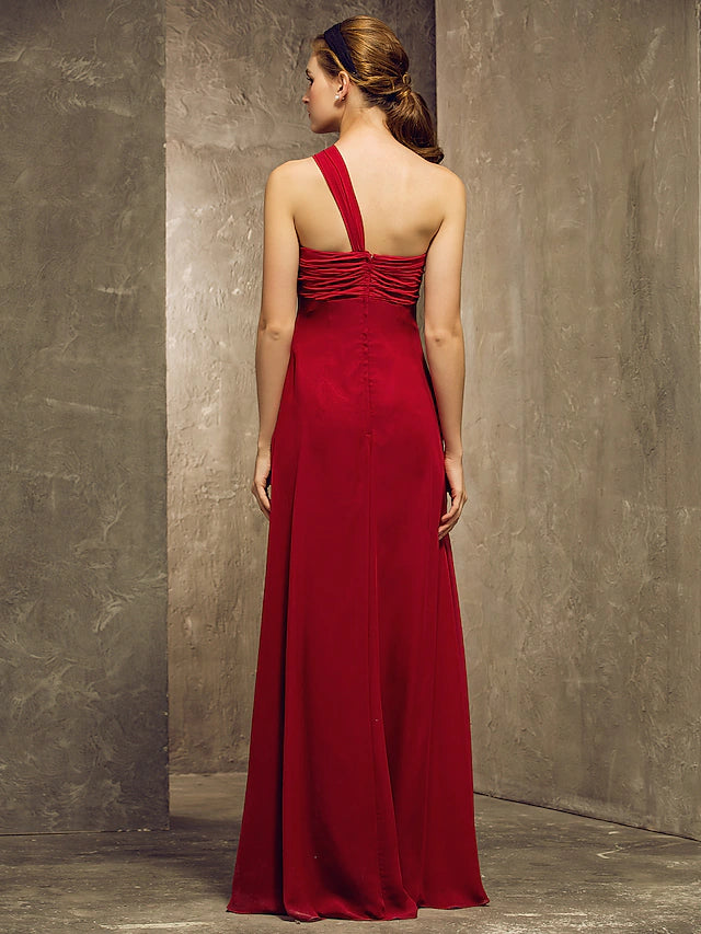 Close-up of the ruched and ruffled details on the one-shoulder chiffon dress.