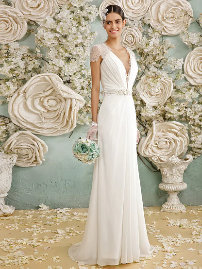 Bride wearing an elegant open back V-neck chiffon wedding dress with long sleeves.