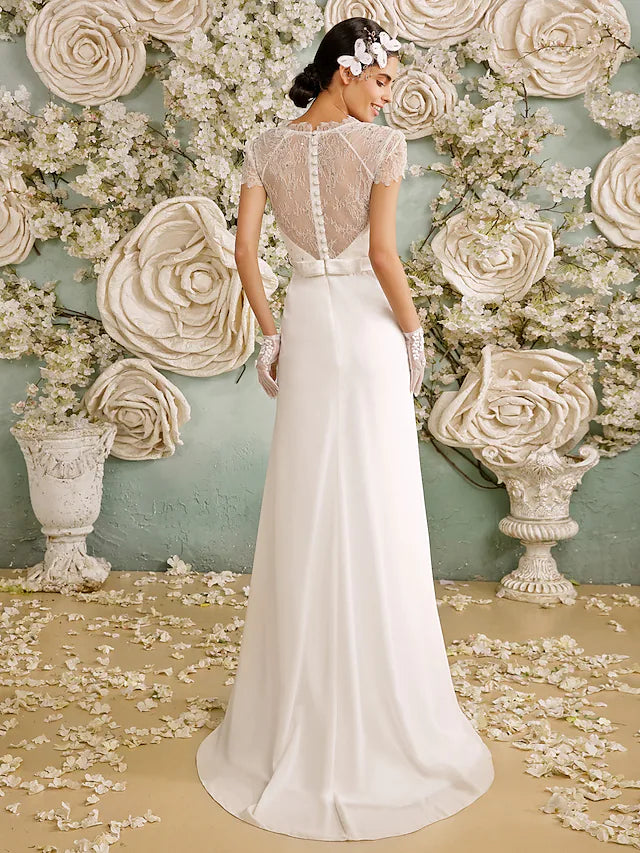 Close-up of the open back and crystal buttons on the chiffon wedding dress.