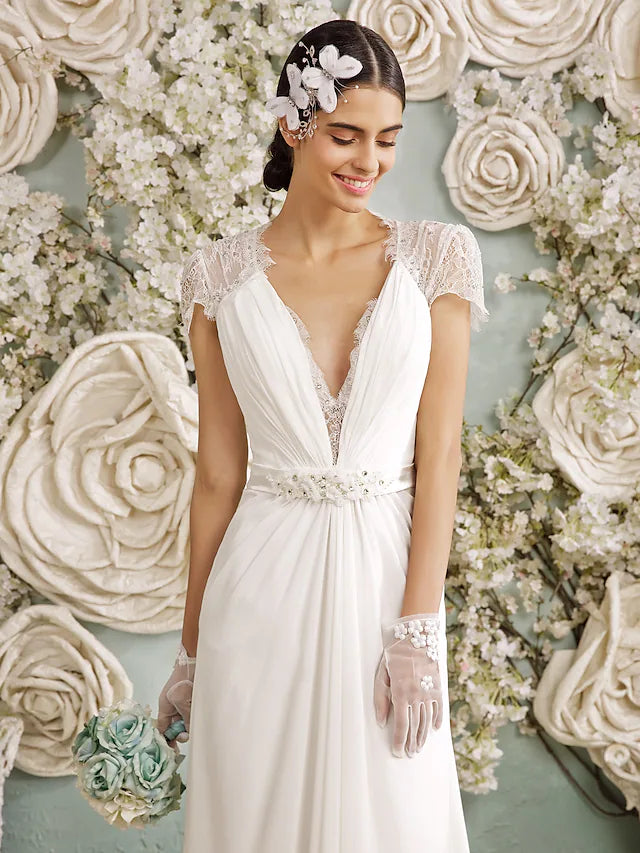 Front view of the V-neckline and long sleeves of the wedding dress.