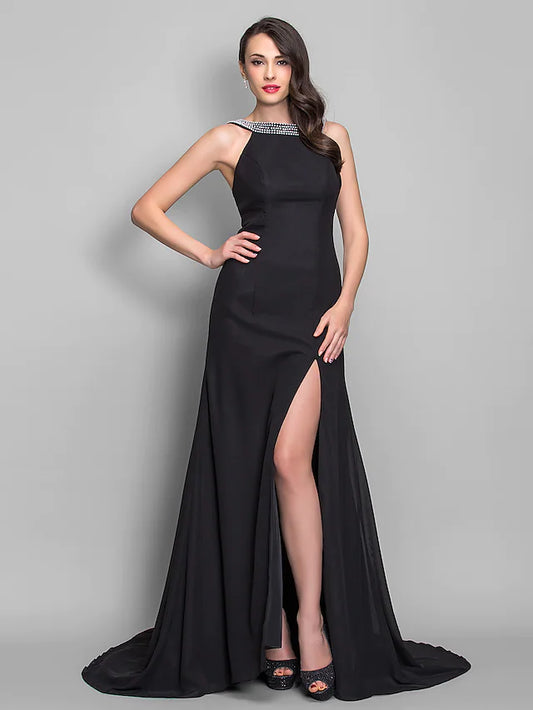 Model wearing an elegant navy open back scoop neck chiffon dress.