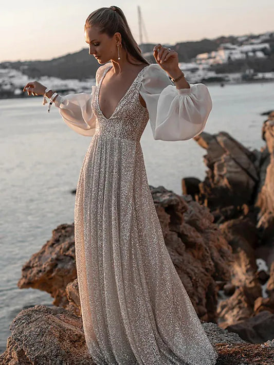 Elegant V-neck long sleeve sequined wedding dress with pleats.