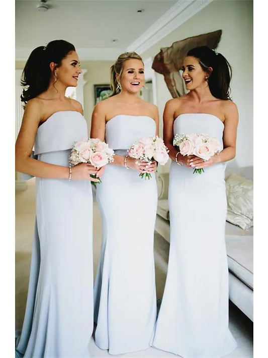 Model wearing an elegant strapless bridesmaid gown with ruffles and bows.
