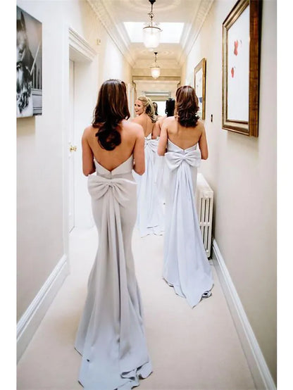 Close-up of the strapless neckline and bow detail on the bridesmaid gown.