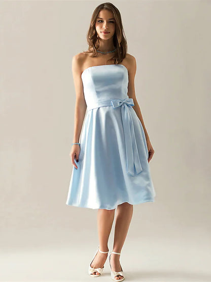 Back view of the knee-length satin bridesmaid dress, showing the sash detail.