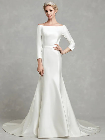 Front view of a white strapless satin wedding dress with elegant pleats and a chapel length train.