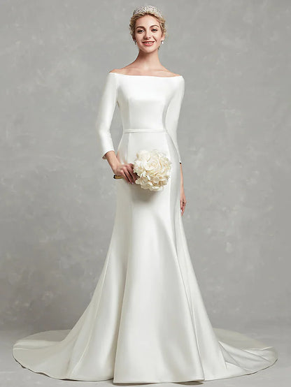 Side view of a bride in a white strapless satin wedding gown, showcasing the pleated detail.
