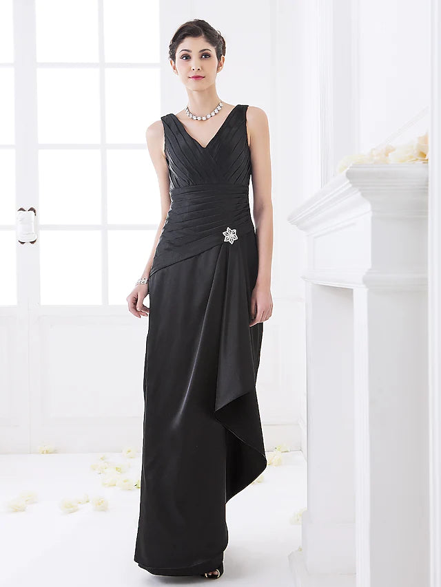 Woman in an elegant V-neck sleeveless floor-length bridesmaid dress with side draping and a crystal brooch.