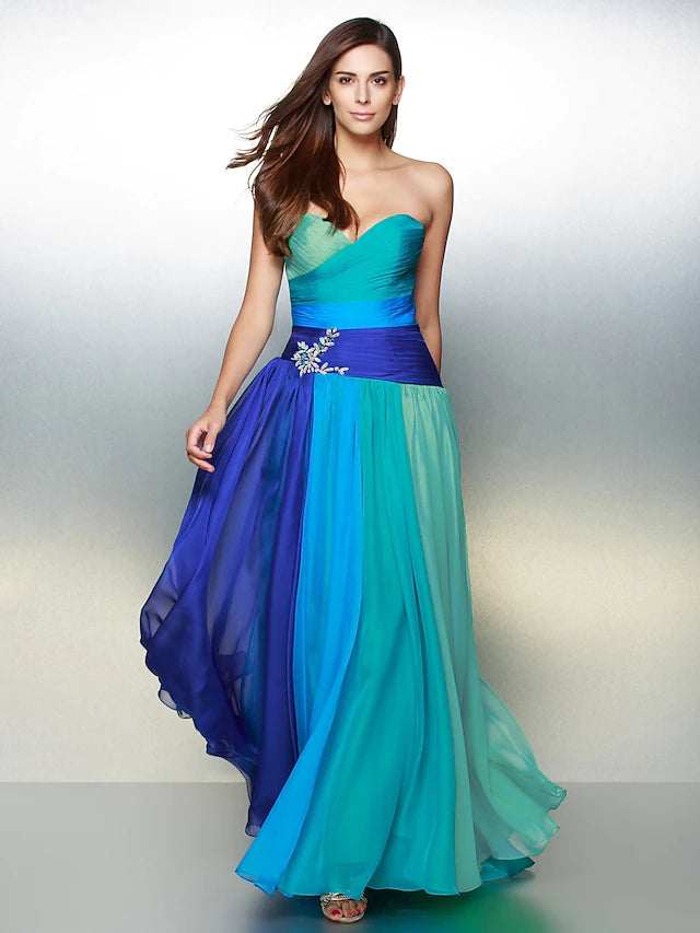 Woman in elegant floor-length chiffon wedding guest dress with sweetheart neckline.
