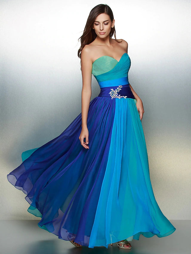 Back view of a woman in a backless chiffon dress with ruched details.