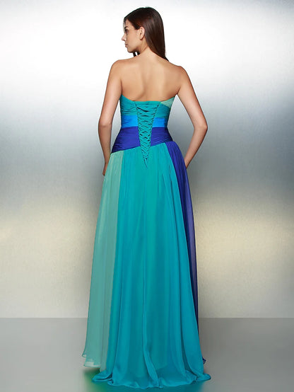 Side view of a woman in a sleeveless floor-length dress with crystal accents.