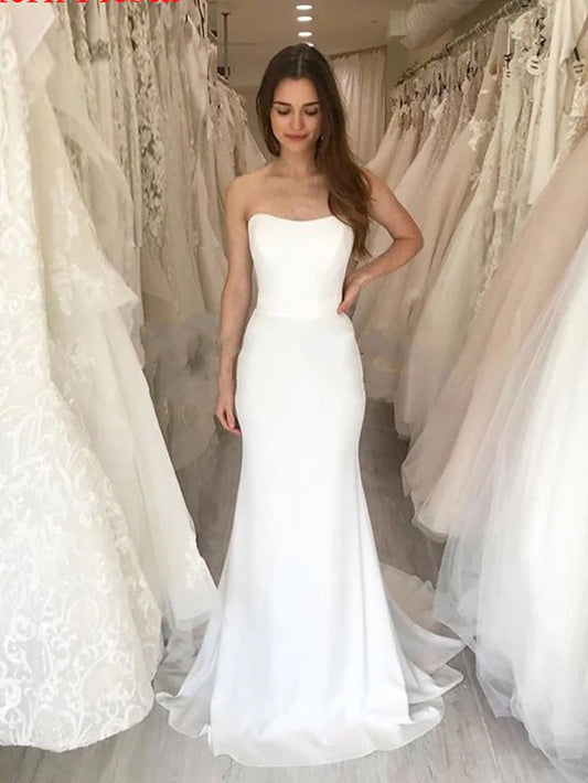 Model wearing an elegant two-piece strapless satin wedding dress, front view.