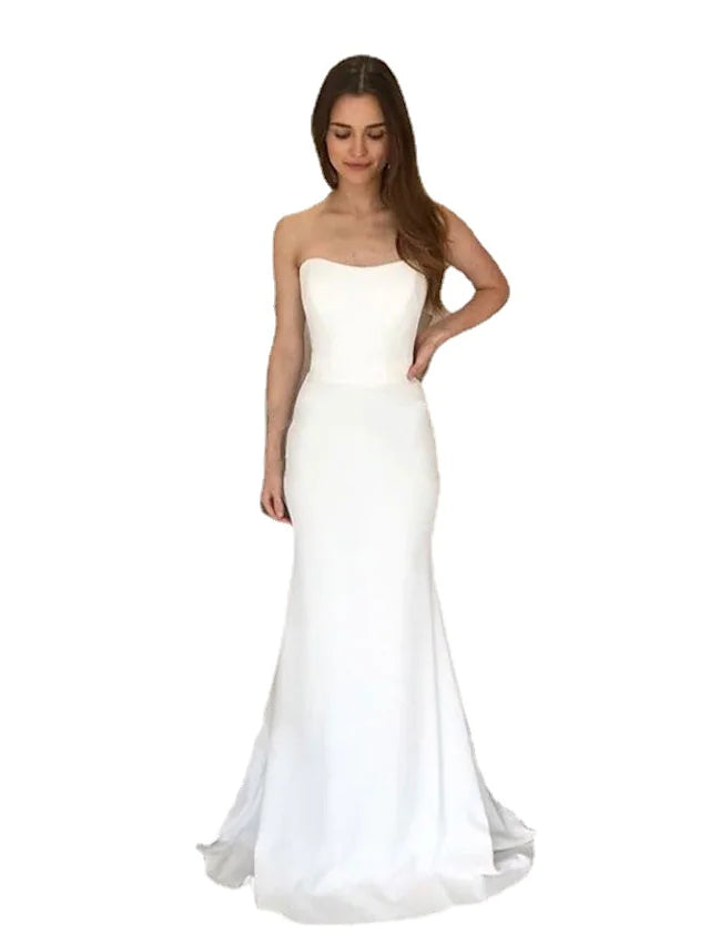 Model in a sophisticated two-piece strapless satin bridal gown, side view.