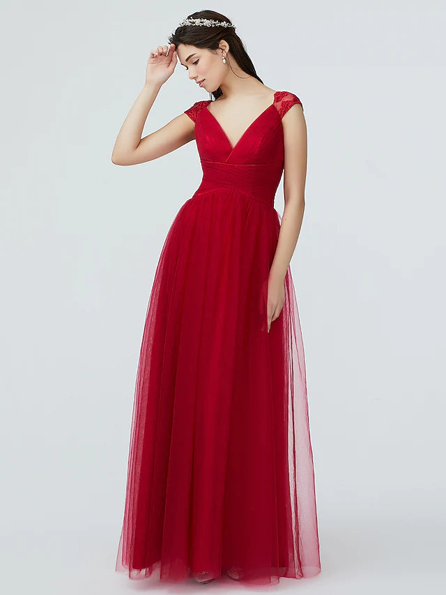 Model wearing a sparkling A-line bridesmaid dress with V-neck and short sleeves.