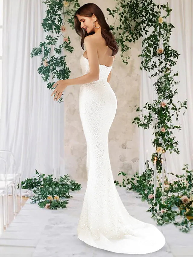 Elegant one-shoulder mermaid wedding dress with sequin and satin details.