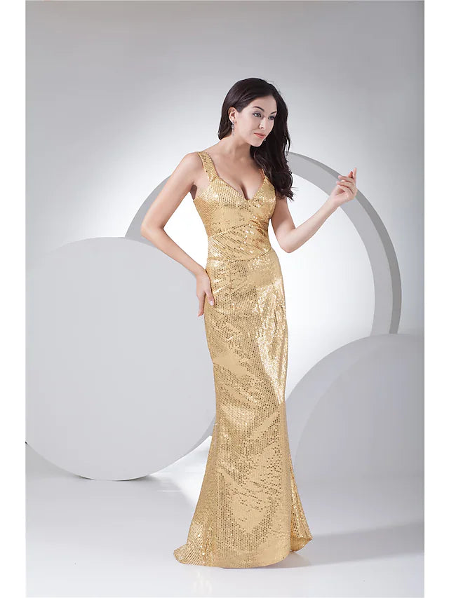 Model in a dark sequined mermaid trumpet evening gown, side view.