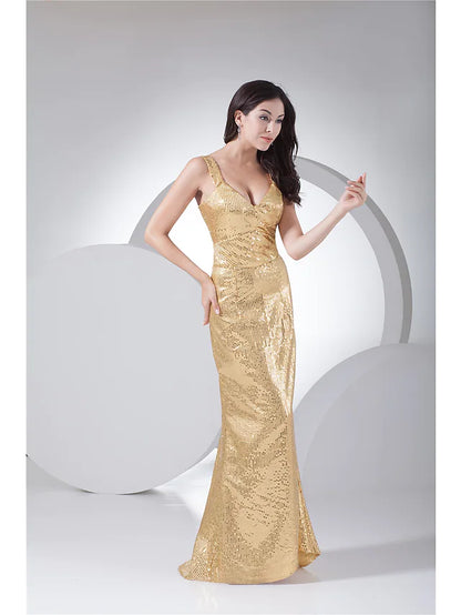 Model in a dark sequined mermaid trumpet evening gown, side view.