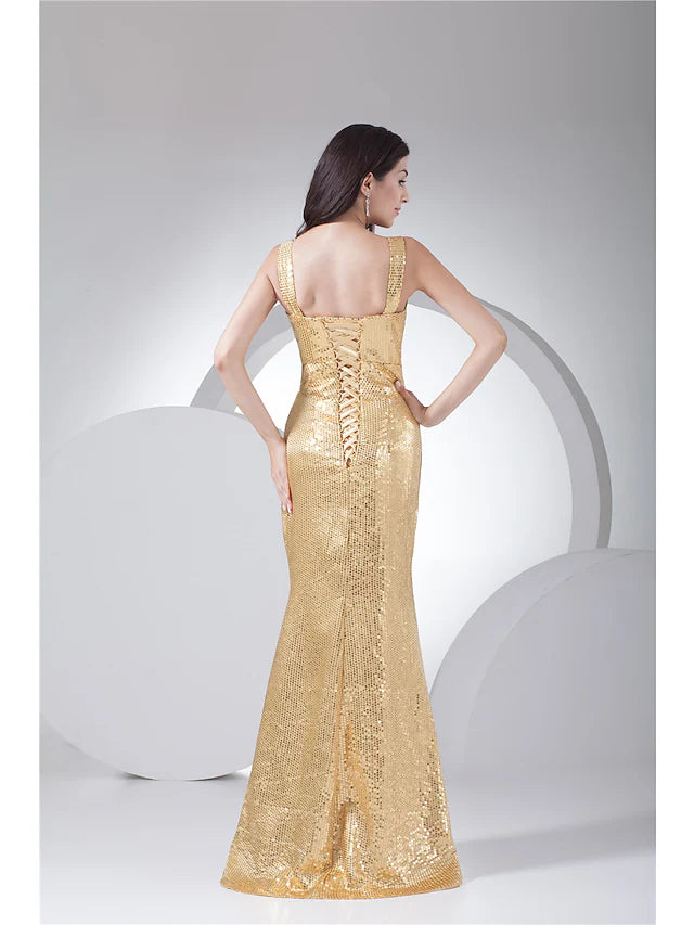 Elegant model posing in a dark sequined mermaid trumpet dress.
