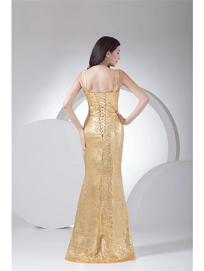 Elegant model posing in a dark sequined mermaid trumpet dress.