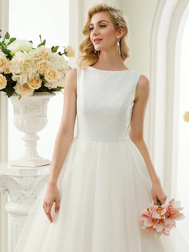 Close-up of the bateau neckline and bodice with intricate lace and sequin embellishments.