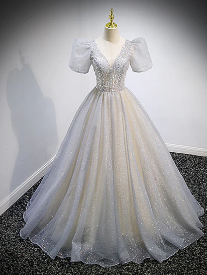 Front view of a sparkling V-neck short sleeve Quinceanera maxi dress with tulle and crystal embellishments.